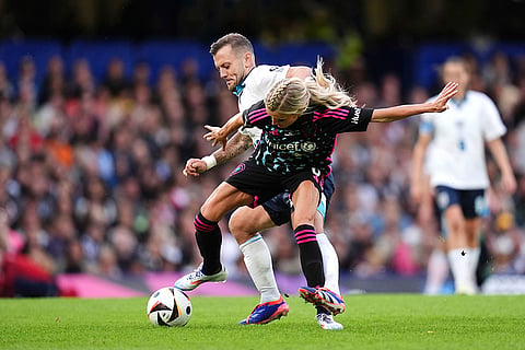  Jack Wilshere and Kaylyn Kyle battle for the ball